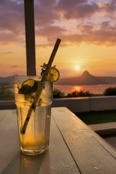 Refreshing mocktail served against a golden Pawna Lake sunset
