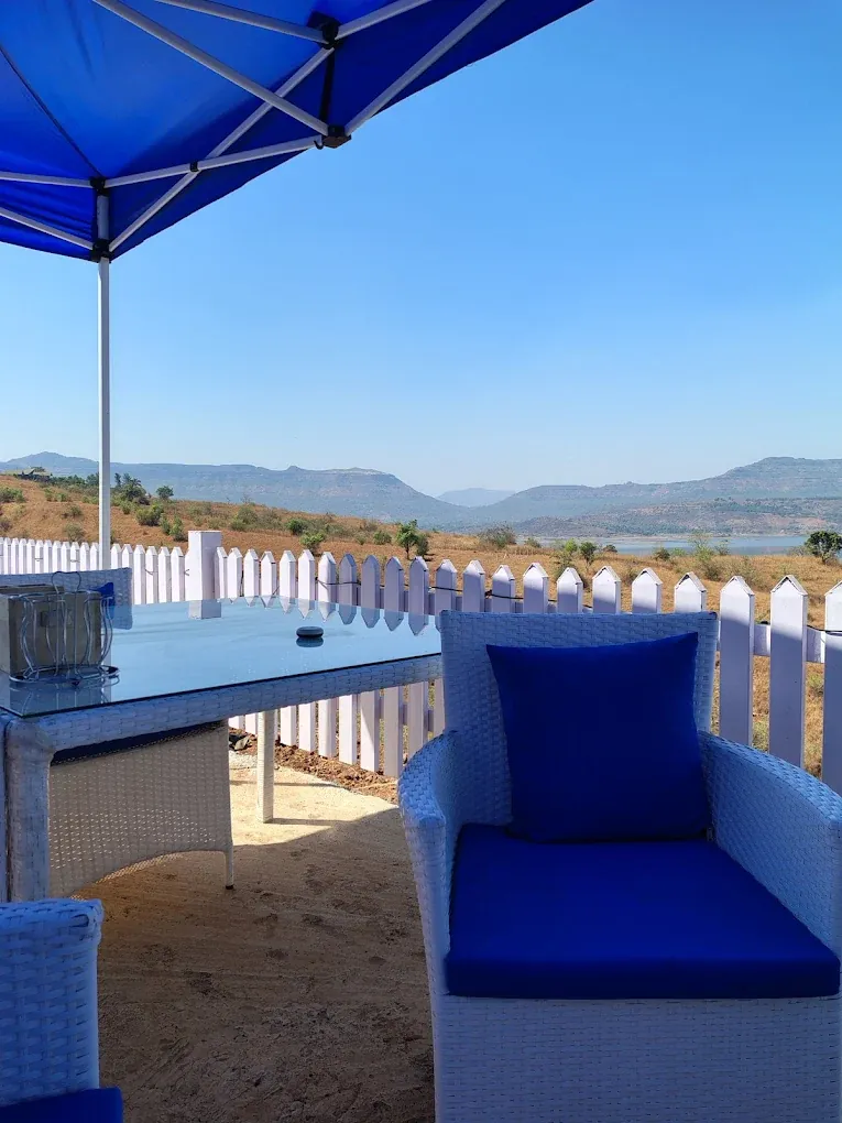 Blue cabana lounge seating on the lakeside deck in Pawna
