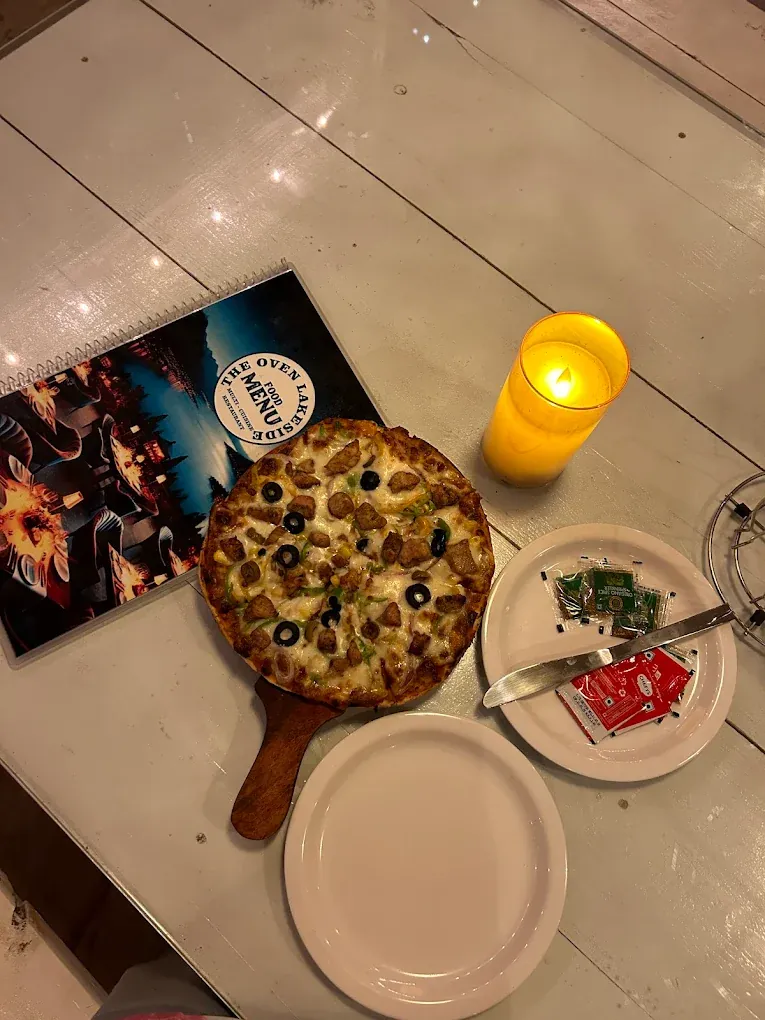 Candlelit pizza platter for an evening lakeside dinner in Pawna