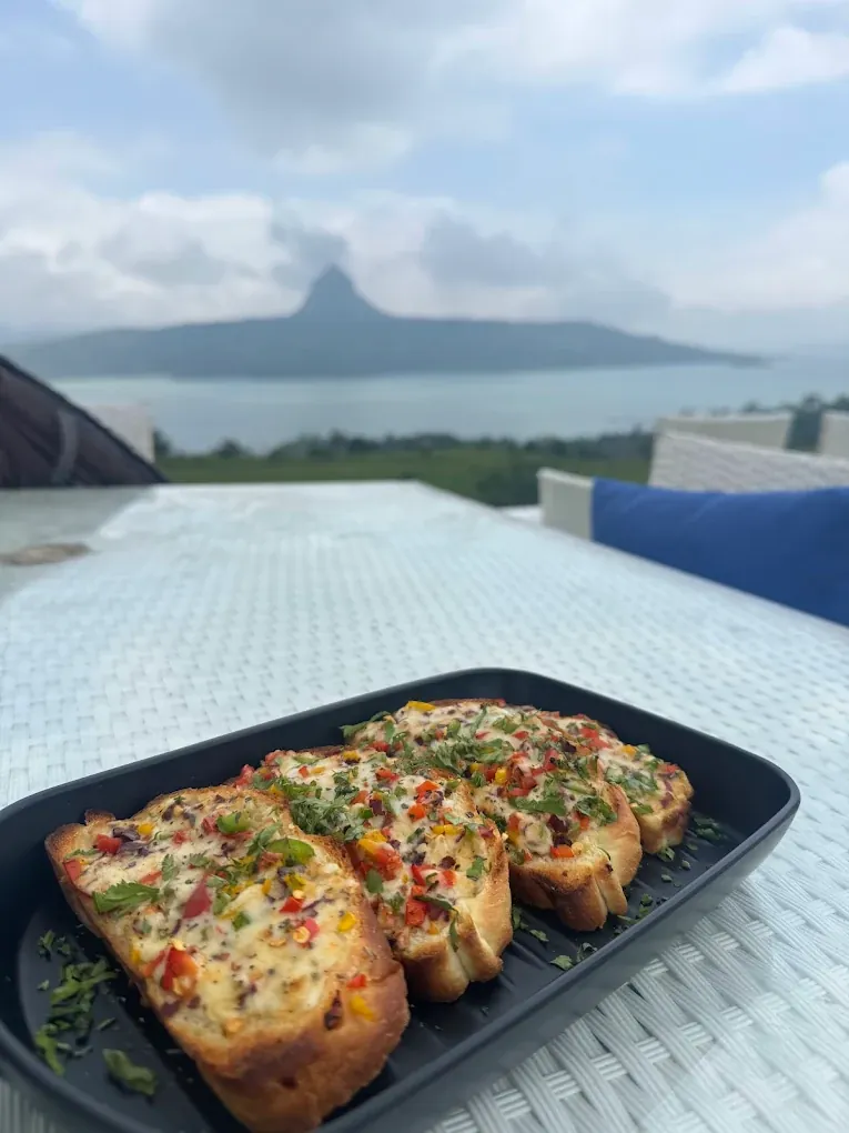 Golden garlic bread served lakeside in Pawna